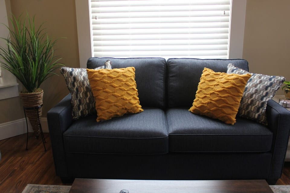 This inviting space is designed to create a sense of serenity and relaxation. The abundant natural light that floods the room accentuates the soothing color palette, creating an atmosphere of calm and tranquility.