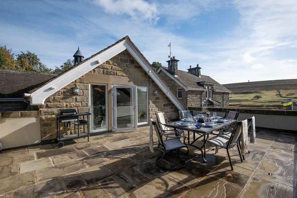 Roundhill Coach House - the large stone flagged terrace area with charcoal barbecue