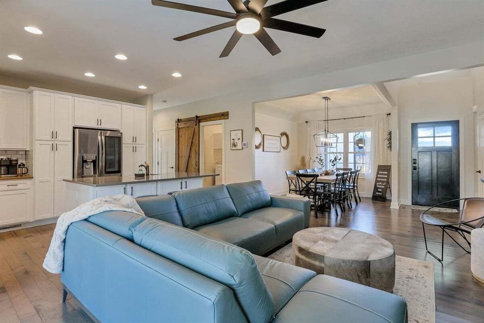 The living room opens seamlessly into the kitchen and dining spaces.