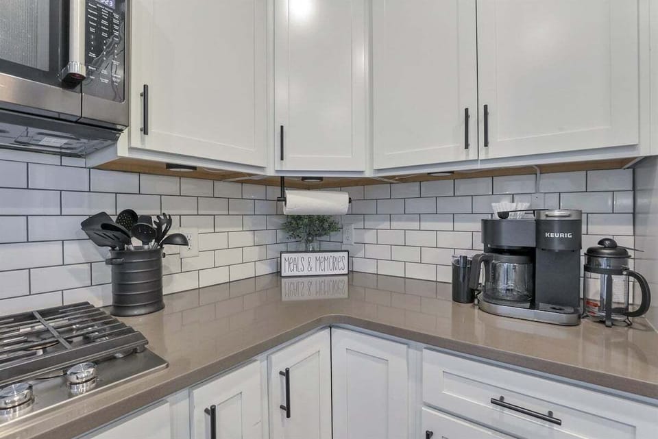 A functional kitchen corner with countertop appliances and storage.