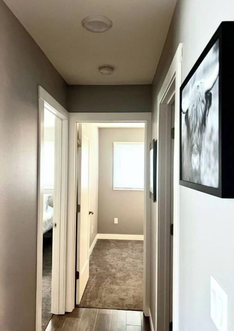 Hallway leading to two bedrooms and bathroom