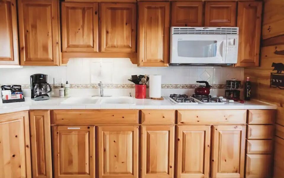 Full kitchen excluding a dishwasher and conventional oven.