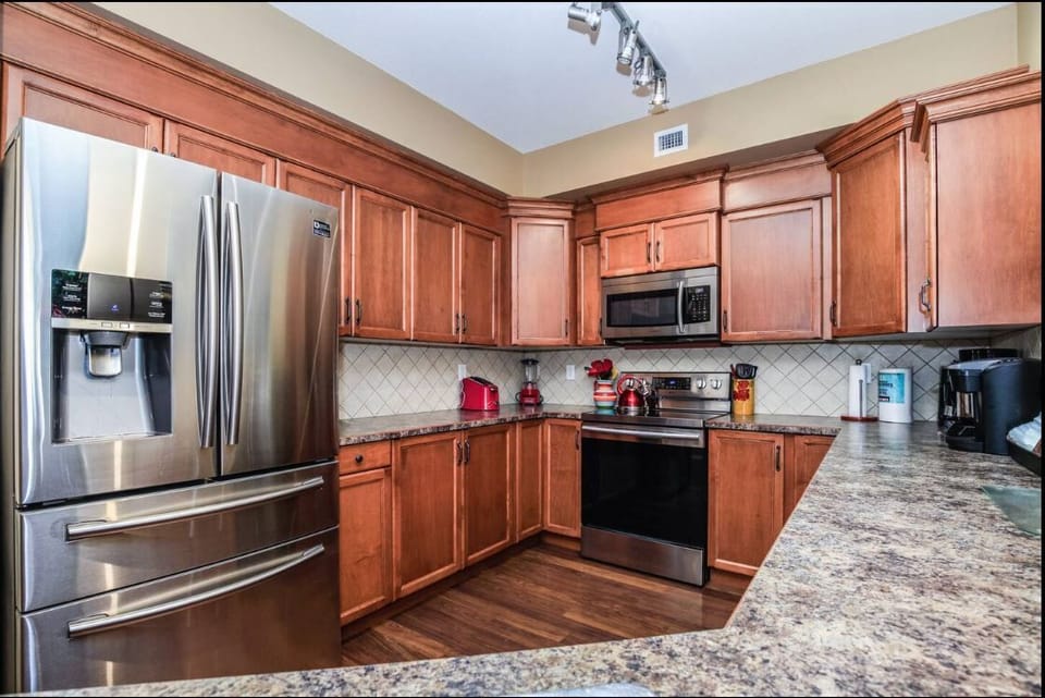Full fridge, microwave, coffee maker, toaster, and blender.