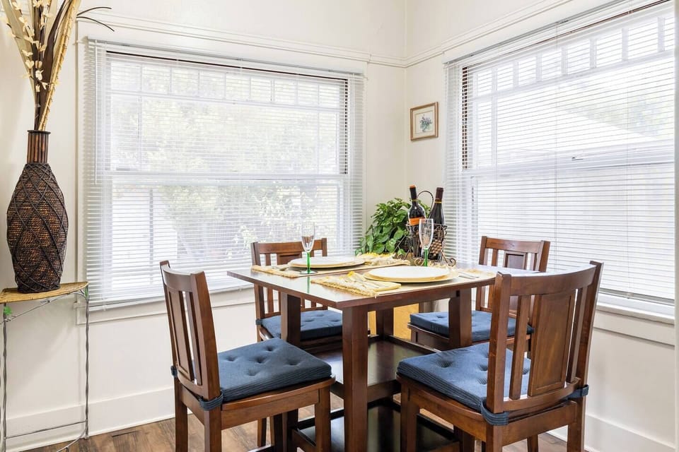 Lovely dinette, brightly lit by large windows.