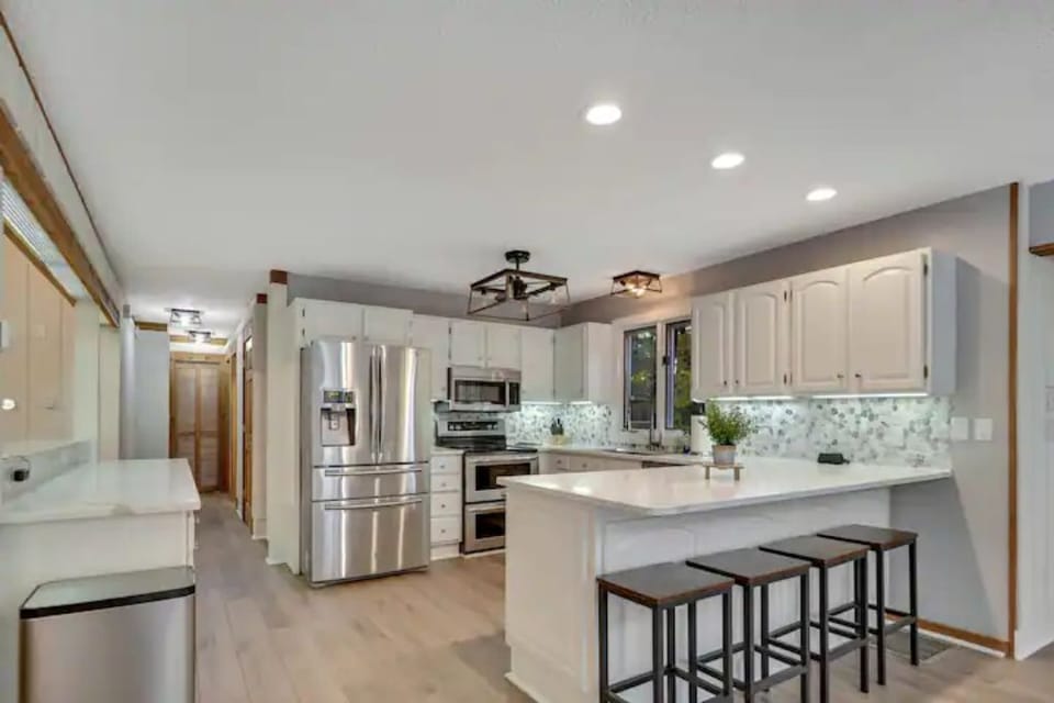 Newly remodeled, fully stocked kitchen with view down the hallway.