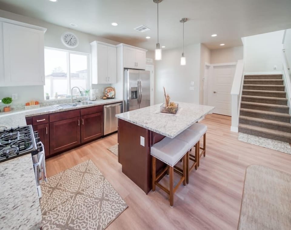 Fully-Stocked Kitchen/Access to Upstairs/Access to Back Patio