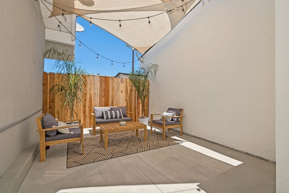 Private outdoor area with sitting, igloo, chairs, plants, market lights.