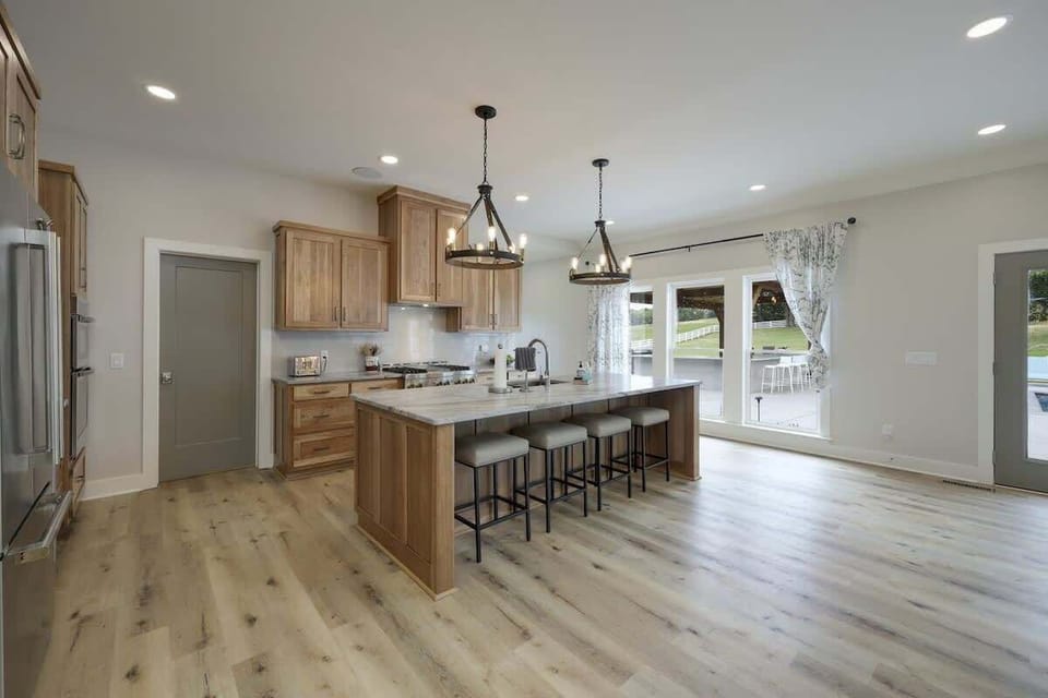 Large gourmet style kitchen with stainless steel appliances, large counter space, breakfast bar seating, breakfast table seating, butlers pantry, and is fully stocked with your basic cooking essentials.