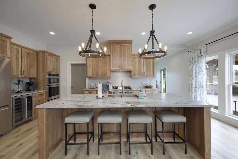 Large gourmet style kitchen with stainless steel appliances, large counter space, breakfast bar seating, breakfast table seating, butlers pantry, and is fully stocked with your basic cooking essentials.