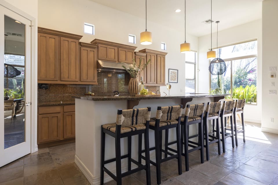 Spacious kitchen features tons of barstool seating at the island counter.