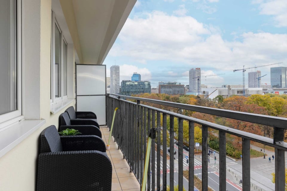 A side view of the balcony, offering a closer look at the seating and the impressive cityscape.
