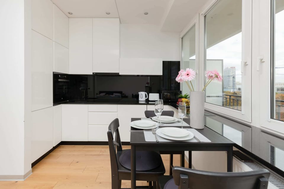 The kitchen area with a dining table set for two, emphasizing comfort and elegance.

