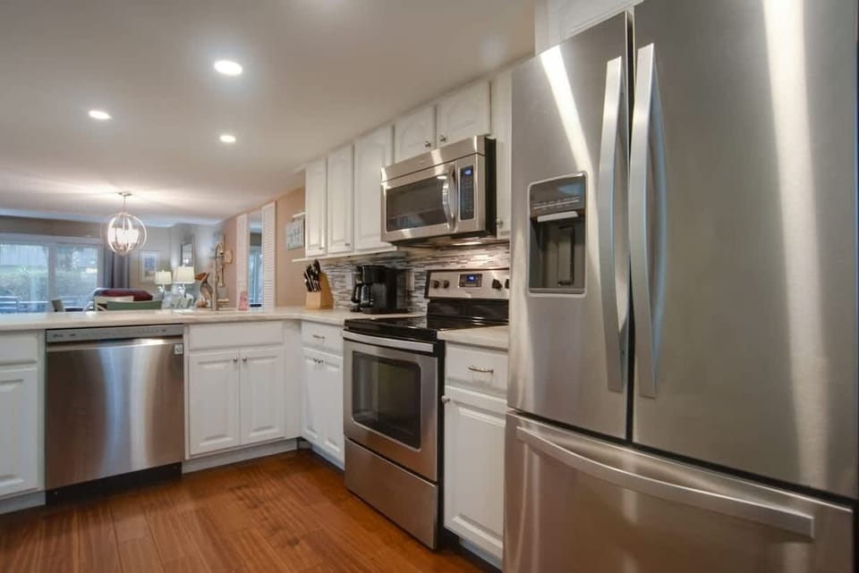 Your fully equipped kitchen sparkles with stainless steel appliances and sleek white cabinets, perfect for creating memorable meals during your stay.