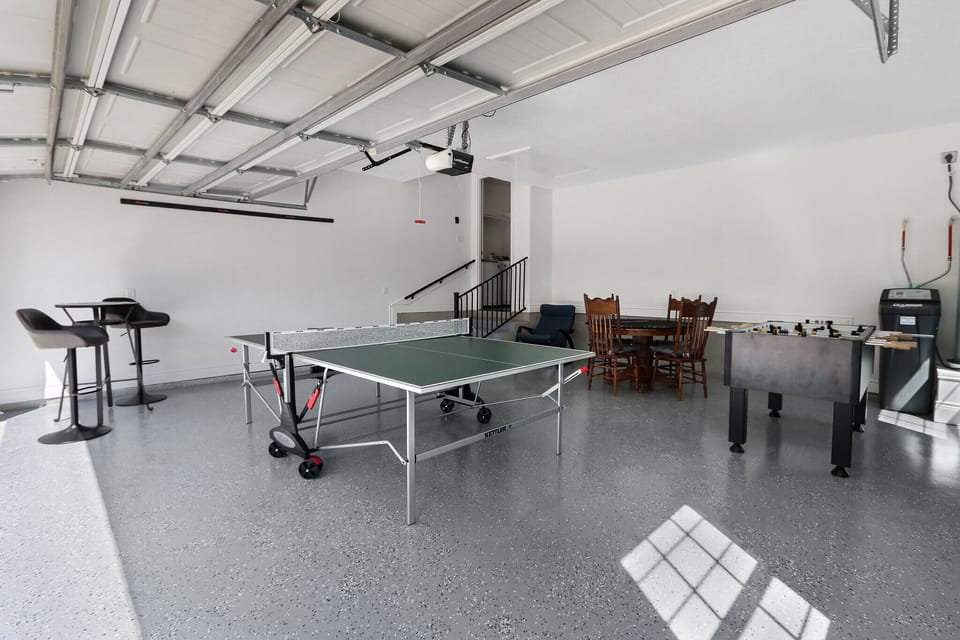 View showing entrance to home from garage.  Ping pong table, foosball and game table can be seen.