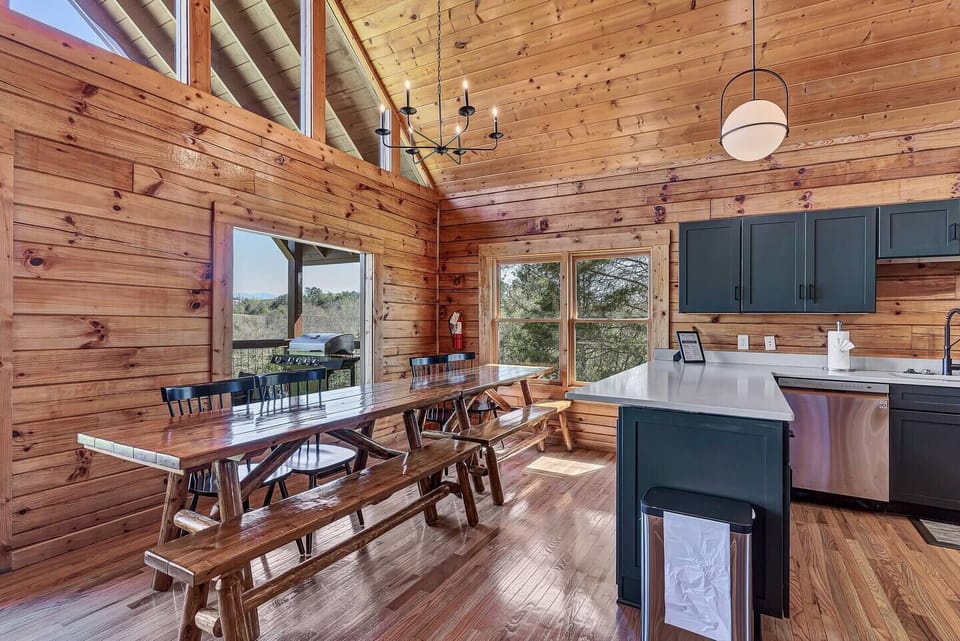 A cabin dining area designed for a house that sleeps 18 is a warm and rustic space that combines comfort with functionality, perfect for hosting large gatherings.