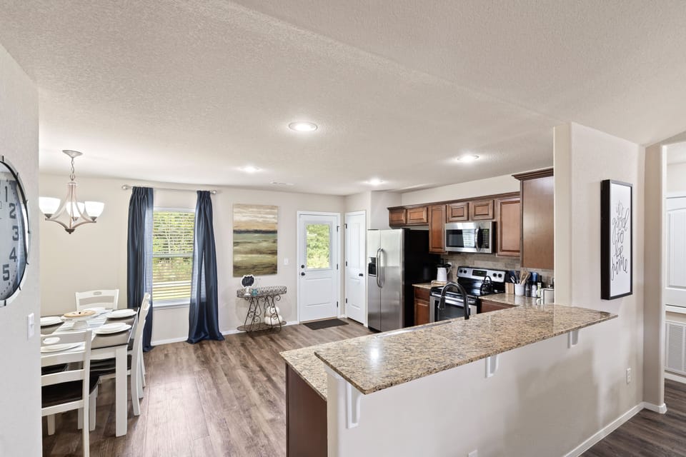 Open concept dining, kitchen, and living is light & airy.