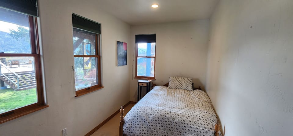 Bedroom with double bed and views of the back yard.