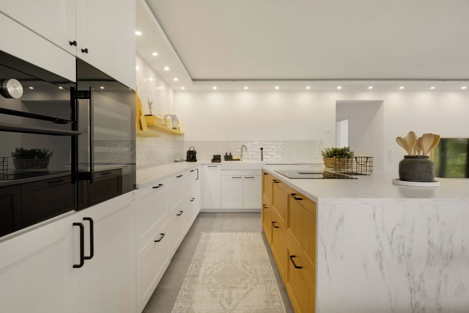 Modern kitchen with marble style countertop and storage