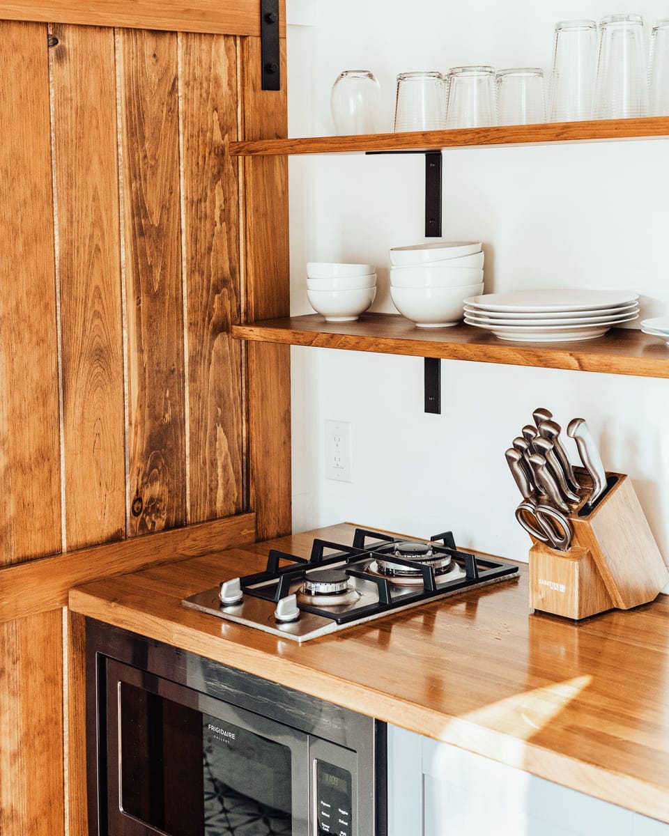 Our kitchen features a two-burner gas stove, microwave , and large toaster oven.