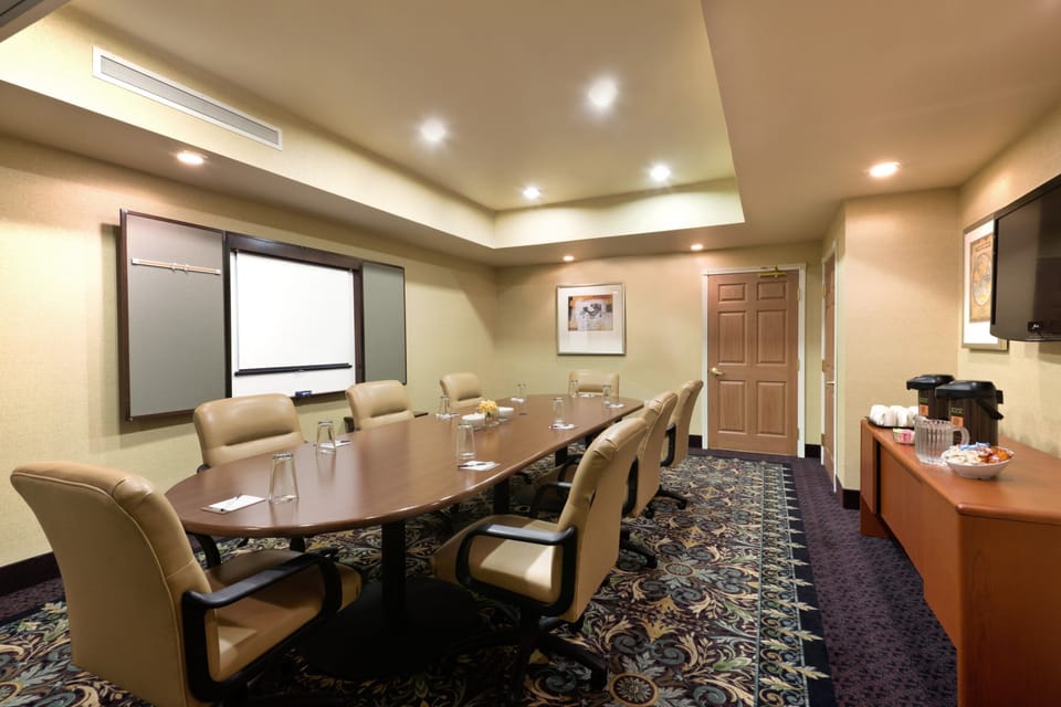 Meeting room with presentation screen and refreshments.