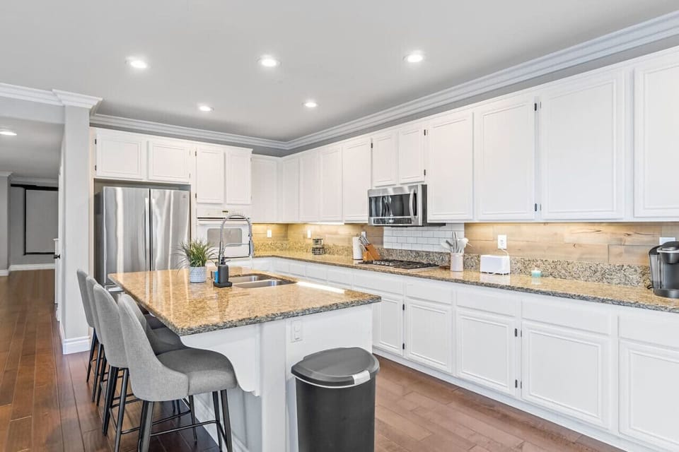 Cook with flair! This well-appointed kitchen features beautiful wood cabinetry, modern stainless steel appliances, and sophisticated stone countertops, seamlessly combining practicality with style.