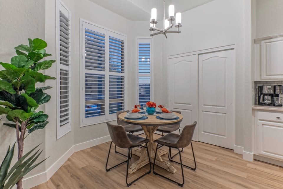 Dining area has table seating for 4 and engaging views of the backyard and park.