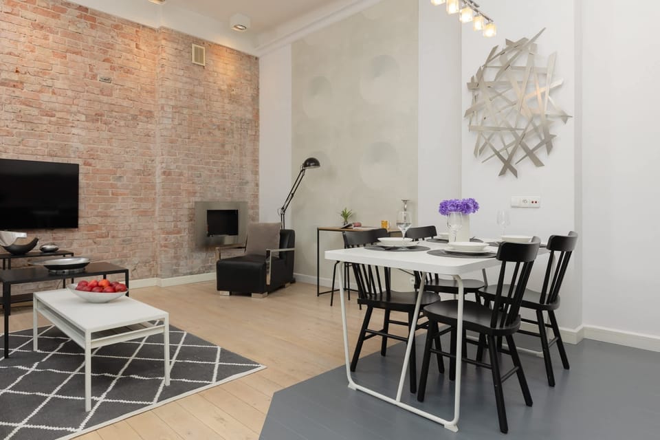 A dining area with a black table, modern chairs, and stylish decor, blending functionality and design.
