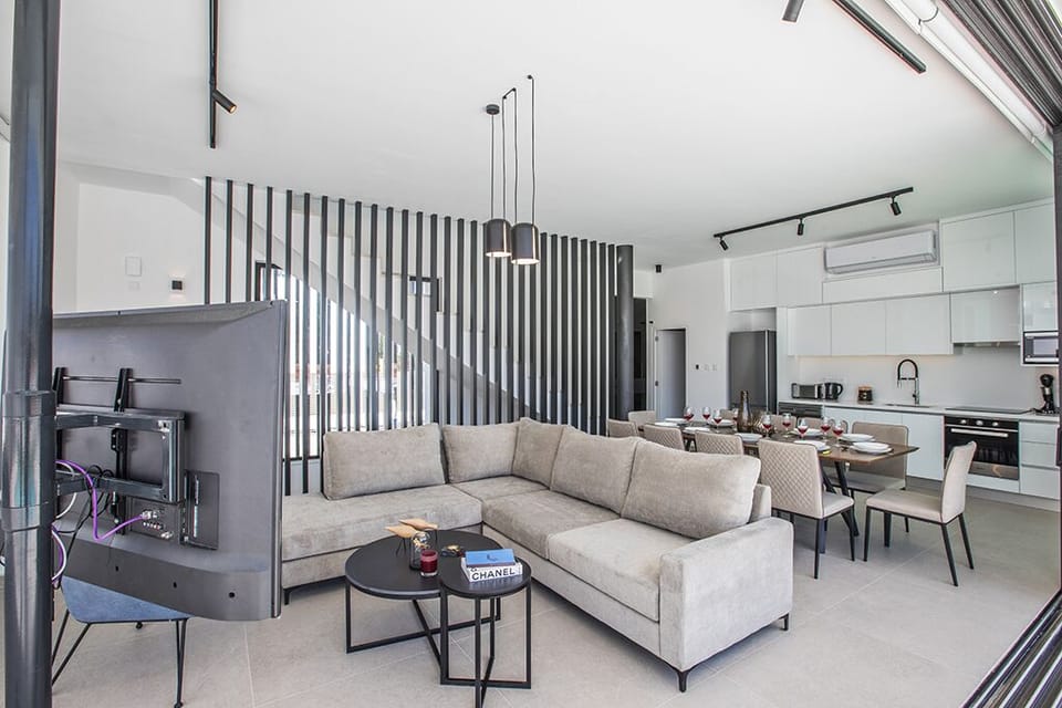 Living room wtih comfortable seating areas and widescreen TV