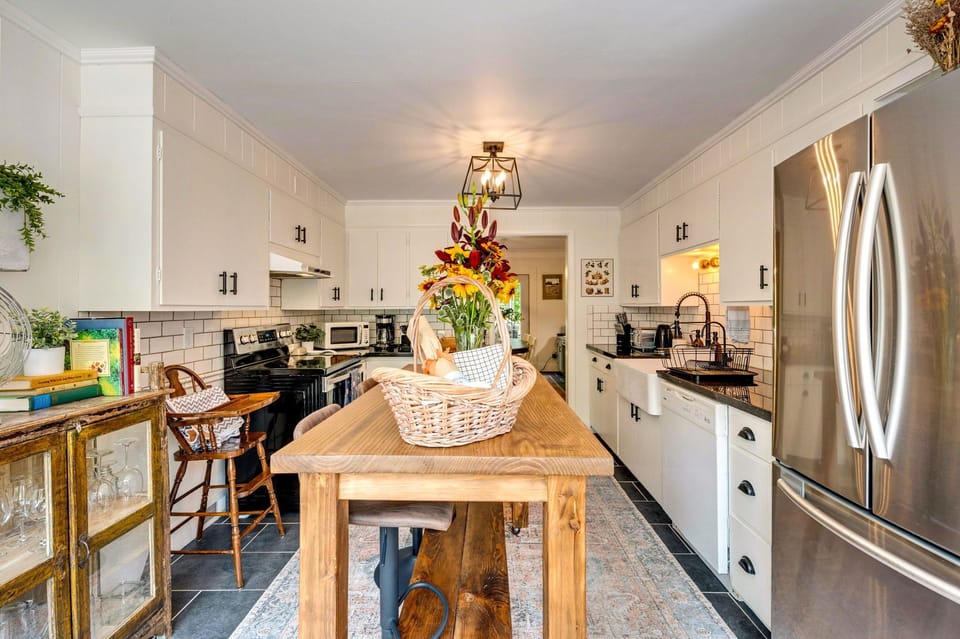Farmhouse sink, subway tiles, and stainless steel appliances