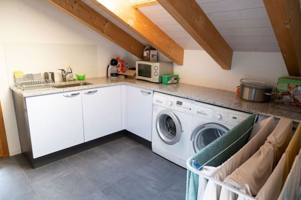 Microwave, coffee machine, washer/drier and additional sink linked to kitchen. 