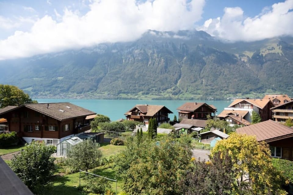 Shot of the village with lake and mountains in the background. 