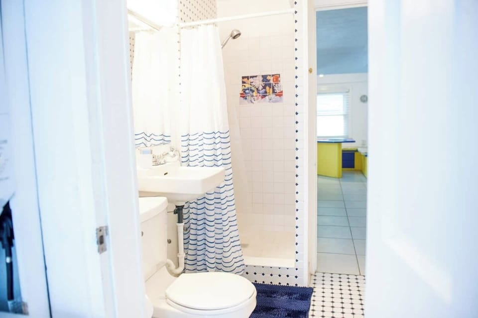 The retro bathroom is decorated with fun subway tiles and leads directly out to the porch, where there is a washer and dryer for your use for free.
