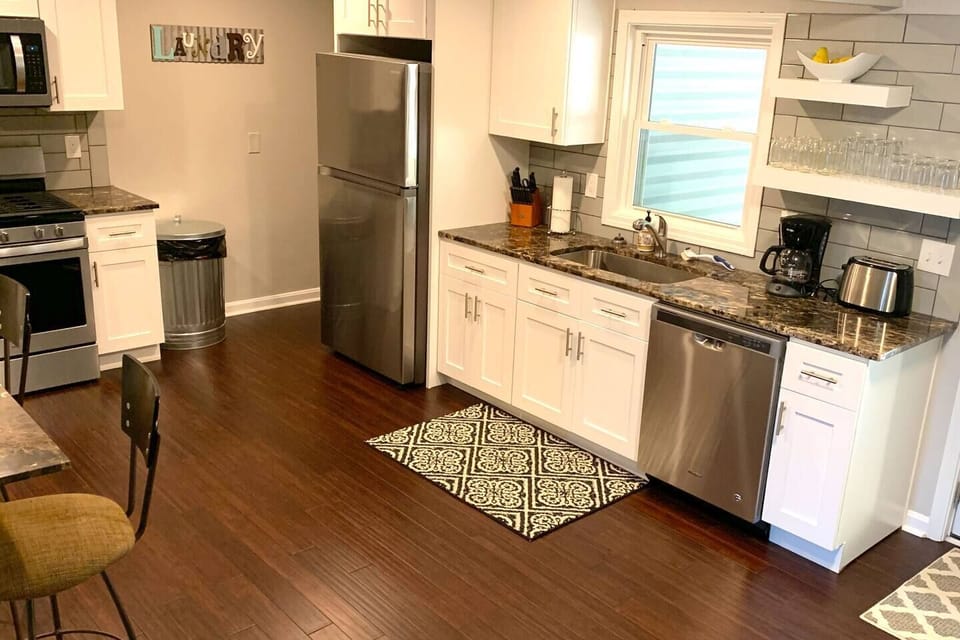 High end kitchen with stainless appliances and gas range