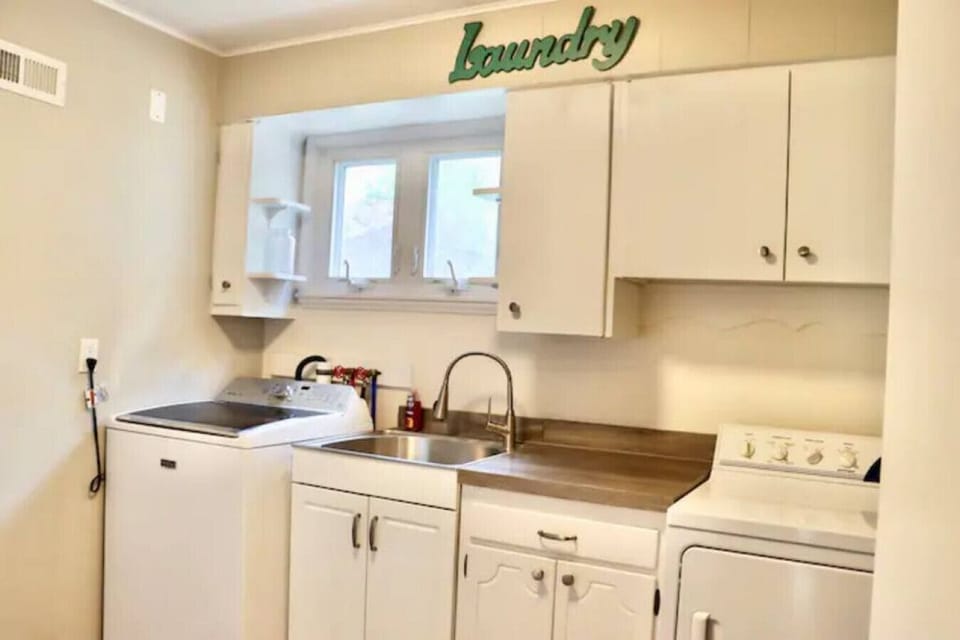 Laundry room with washer, dryer, and sink