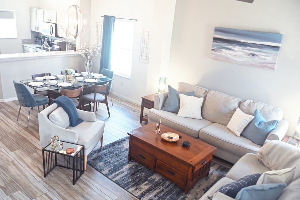 A glance through the open-concept living area into the updated kitchen.