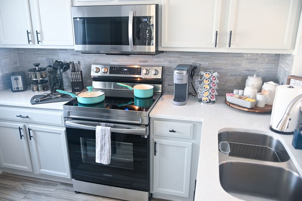 A well-equipped kitchen includes pots, pans, cooking utensils, spices, and more.