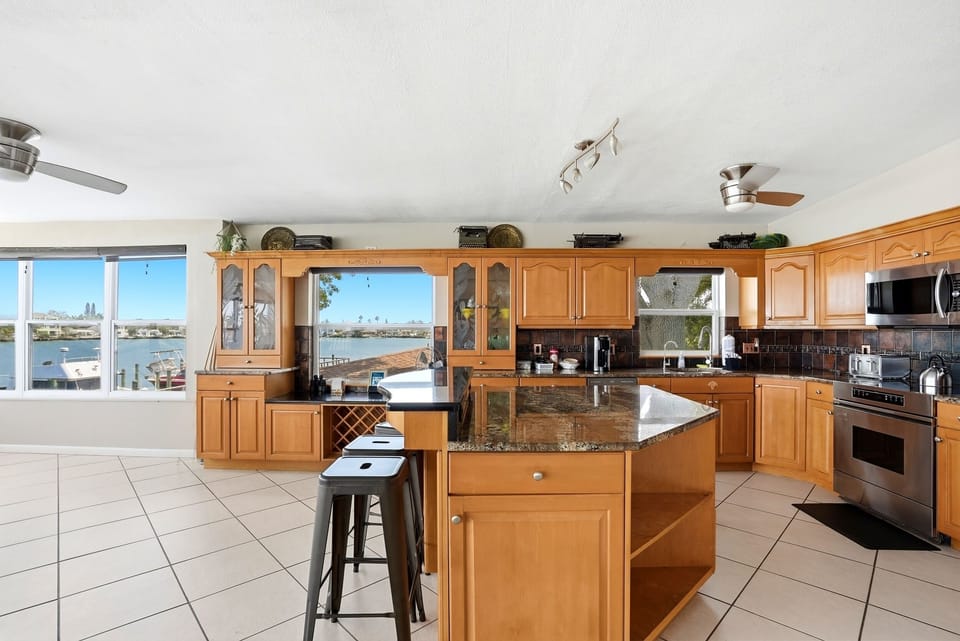 This spacious kitchen is fully stocked with all of your cooking needs.  Appliances include a stove, oven, microwave, blender, mini magic bullet, and toaster.  We also provide a complete set of plates, bowls, glasses,  wine glasses, mugs, & utensils.