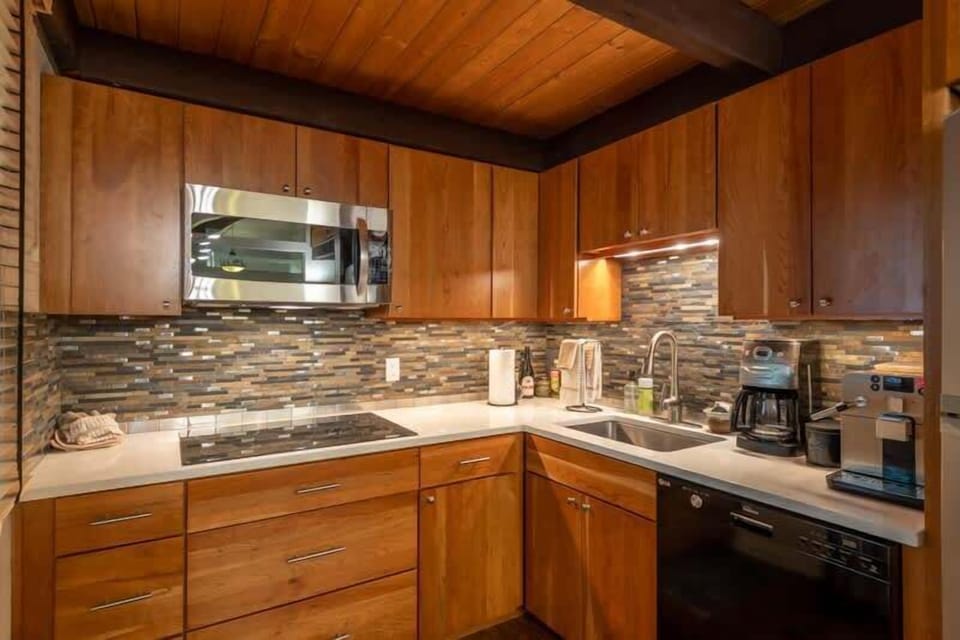 Kitchen with Glass Stovetop, Microwave, Full Size Fridge, and Espresso Machine