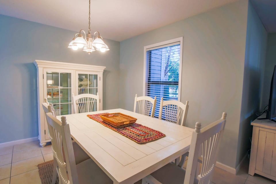 The dining room is situated between the kitchen and living room areas.