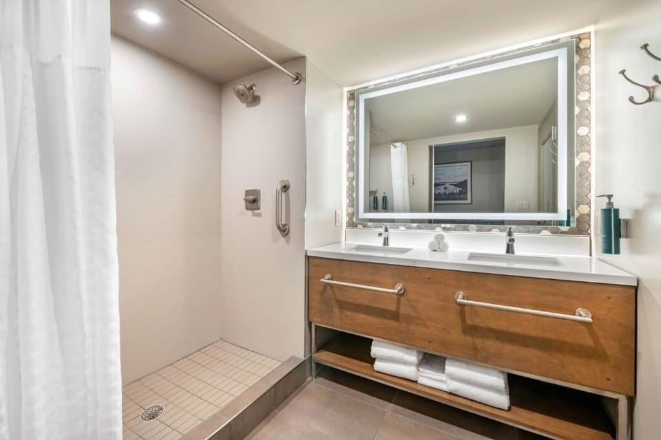 Refresh under a spacious shower and bright vanity lighting.