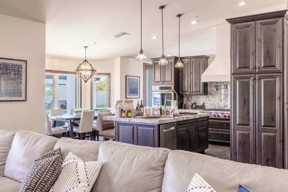 Gather in our stylish, open kitchen & living space with pool views.