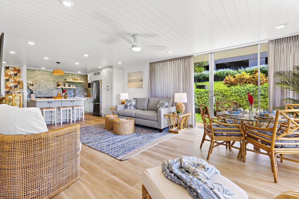 Spacious Open-Concept Living & Dining - Bright and airy open-concept space featuring a modern kitchen, comfortable living area, and garden-view dining nook.