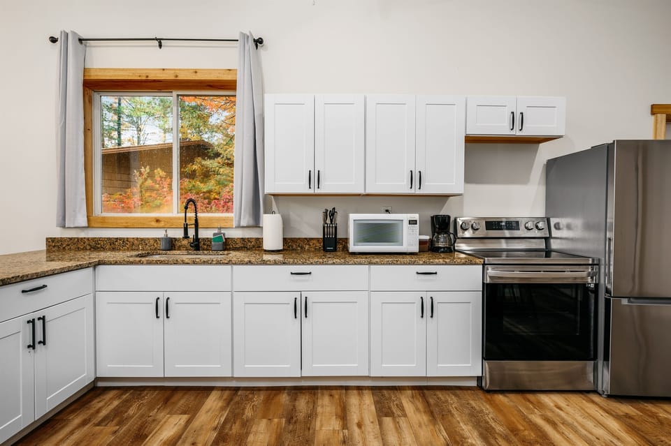 Enjoy culinary adventures surrounded by sleek appliances and vibrant autumn views!