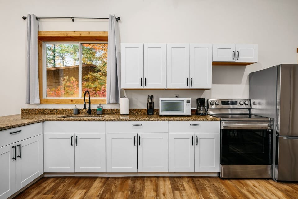 Enjoy culinary adventures surrounded by sleek appliances and vibrant autumn views!