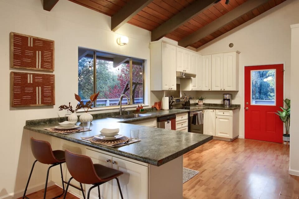 This beautiful kitchen has 2 bar-seats perfect for breakfast! The large window above the sink makes washing into a scenic experience.
