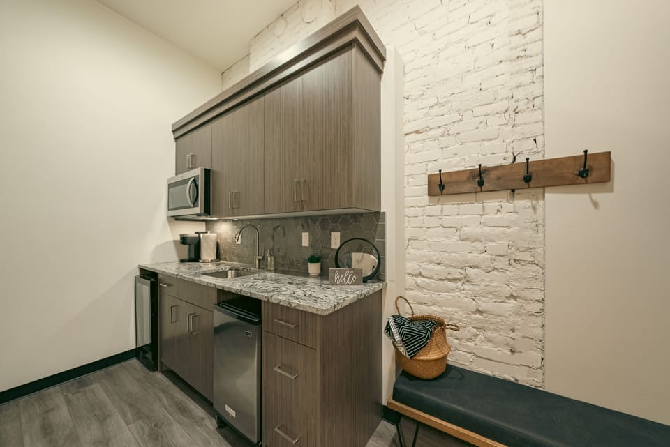 Bench with Hooks near Kitchenette with mini fridge, mini freezer, sink & coffee!