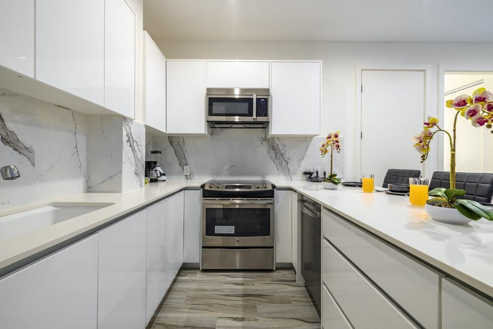 This modern kitchen/dining area brings joy into cooking and makes eating a pleasurable experience.