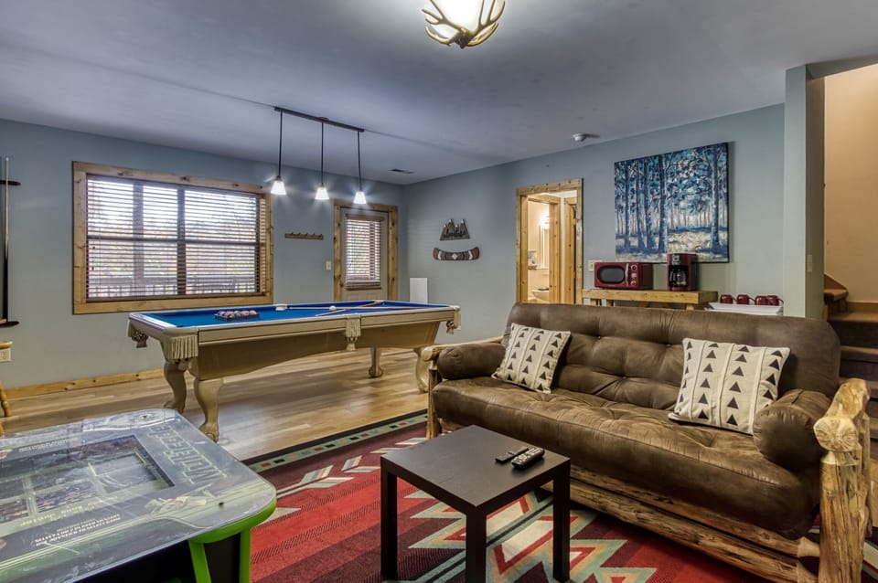 Love this game room, pool table, arcade, tv, futon, door to large covered deck