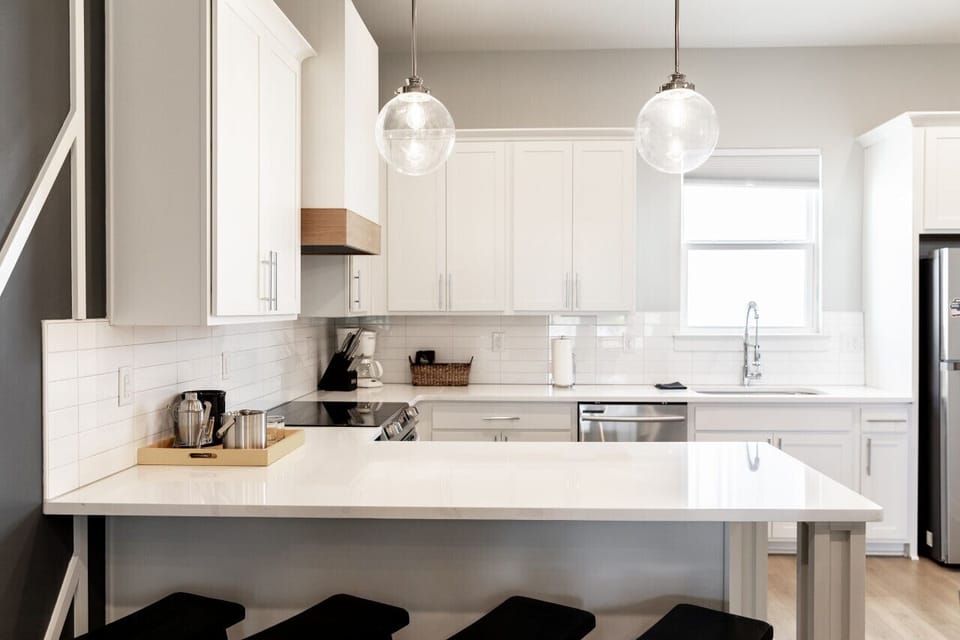 Bright, fully-equipped kitchen with seating for 4 at the counter plus a dining table with seating for 6. Opens up into the living room.