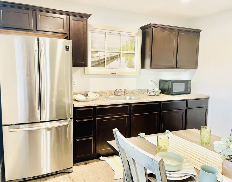Kitchenette has full size LG fridge with ice maker. Crockpot in lower cabinets.